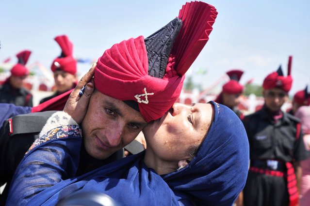 A Kashmiri woman kisses her son, a newly recruited soldier of Indian army during the graduation parade ceremony on the outskirts of Srinagar, Indian controlled Kashmir, Thursday, June 5, 2025. (Photo by Mukhtar Khan/AP Photo)