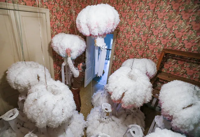 Artisan Karl Kersten adjusts a hat covered with ostrich feathers worn by the “Gilles of Binche” performers ahead of the Carnival of Binche, in Binche, Belgium, 15 January 2018. The carnival, which is now a UNESCO World Heritage event, is one of the biggest and the most popular events in Belgium. It will end with a parade of the “Gilles of Binche” on 13 February 2018. (Photo by Stephanie Lecocq/EPA/EFE)