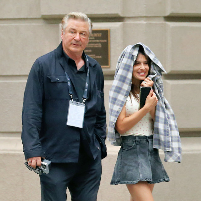 American yoga instructor Hilaria Baldwin cracks up using her plaid jacket as an umbrella walking home with Alec Baldwin in New York City in the first decade of June 2025. (Photo by Christopher Peterson/Splash News and Pictures)