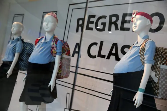 Mannequins of pregnant schoolgirls are seen in a shop window at a shopping mall in Caracas November 12, 2014. A display showing mannequins of pregnant schoolgirls at a Caracas mall is shocking shoppers and stirring debate over s*x education in Venezuela. Two local charities have dressed up three mannequins behind a shop window as girls with bulging stomachs under the blue uniforms used by schoolchildren here until age 15. (Photo by Carlos Garcia Rawlins/Reuters)