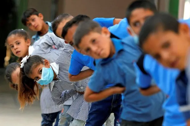 Palestinian students exercise at their school as schools reopen gradually amid the coronavirus disease (COVID-19) outbreak, in Susya village in the Israeli-occupied West Bank on eptember 7, 2020. (Photo by Mussa Qawasma/Reuters)