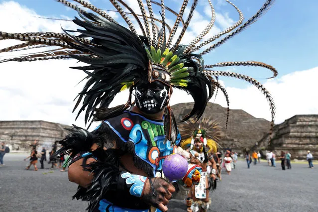 A dancer wearing pre-Hispanic themed clothing performs a ritual for corn, as he protests with Greenpeace volunteers against the growing of transgenic corn, or genetically modified corn, in the country during National Corn Day celebration at the archeological site of Teotihuacan, Mexico September 29, 2016. (Photo by Carlos Jasso/Reuters)
