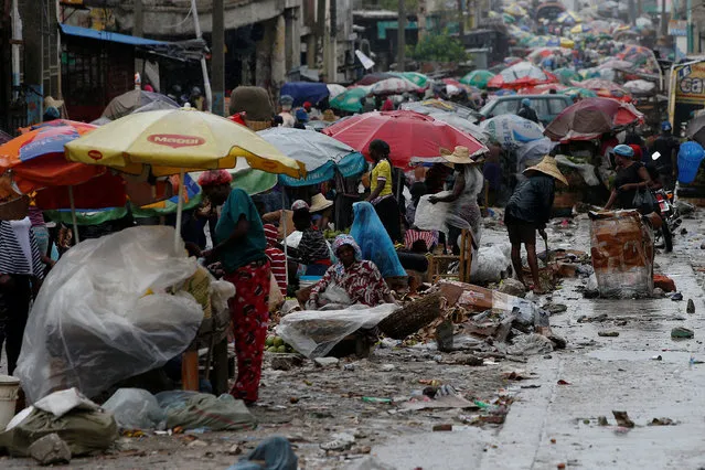 Vendors sell their goods on the street while Hurricane Matthew approaches in Port-au-Prince, Haiti October 3, 2016. (Photo by Carlos Garcia Rawlins/Reuters)