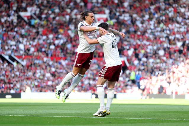 Riccardo Calafiori of Arsenal celebrates scoring his team's first goal with teammate Declan Rice during the Premier League match between Manchester United and Arsenal at Old Trafford on August 17, 2025 in Manchester, England. (Photo by Michael Regan/Getty Images)