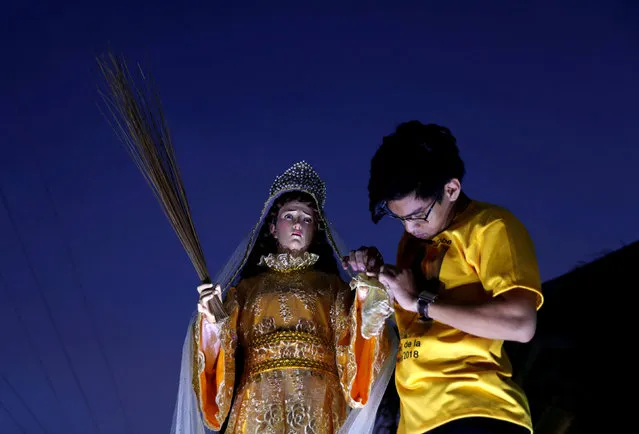 A devotee takes part during a procession of religious images during Holy Week celebrations in Pola, Oriental Mindoro, Philippines March 28, 2018. (Photo by Erik De Castro/Reuters)