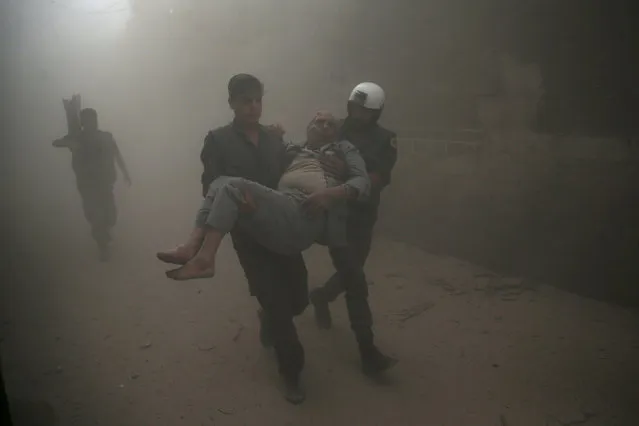 Civil defense members carry an injured man after an air strike in the rebel-held Douma neighbourhood of Damascus, Syria October 12, 2016. (Photo by Bassam Khabieh/Reuters)