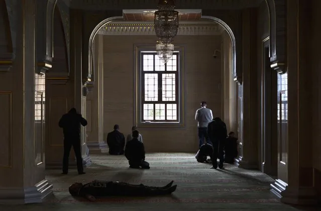 Muslim men wait for Friday prayers in the Heart of Chechnya Mosque in the Chechen capital Grozny April 26, 2013. (Photo by Maxim Shemetov/Reuters)