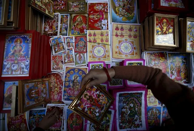 Posters of the Goddess of Wealth, Laxmi is seen on sale by a vendor along the streets of Kathmandu, Nepal, November 9, 2015. (Photo by Navesh Chitrakar/Reuters)