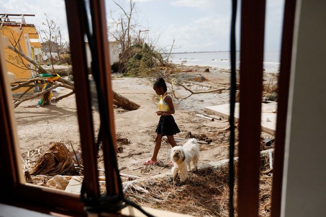 A child and a dog walk in Black River, Jamaica, on Thursday, October 30, 2025, two days after Hurricane Melissa made landfall. (Photo by Octavio Jones/Reuters)