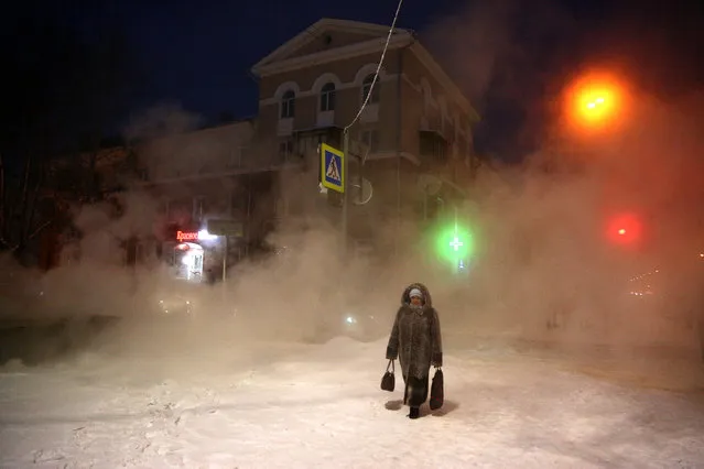 A woman walks in a street in freezing weather of –24 degrees Celsius in Omsk, Russia on January 13, 2021. Daytime temperatures have been below –20 degrees Celsius in the Omsk Region since 25 December 2020. (Photo by Yevgeny Sofiychuk/TASS)