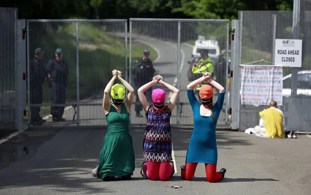 Demonstrators wear “Free p*ssy Riot” balaclavas as they protest at the security fence surrounding the G8 Summit at Lough Erne in Enniskillen, Northern Ireland June 17, 2013. (Photo by Cathal McNaughton/Reuters)