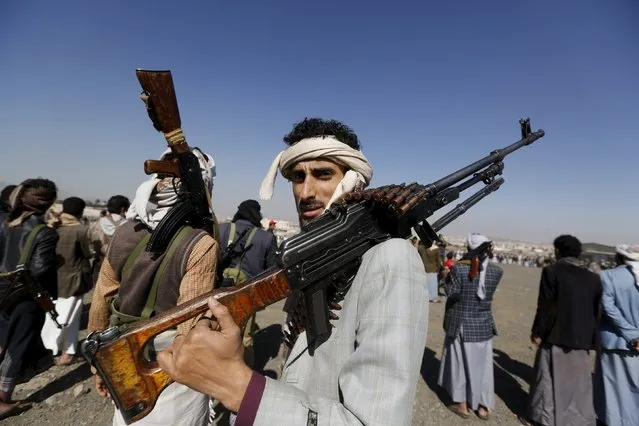 A tribesman loyal to the Houthi movement holds a machine gun as he attends a gathering to show support for the group in Yemen's capital Sanaa December 14, 2015. (Photo by Khaled Abdullah/Reuters)