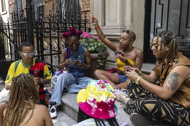 People play a game of Uno during a Queer Juneteenth Block Party, sponsored by The Center, on Sunday, June 18, 2023, in New York. (Photo by Jeenah Moon/AP Photo)