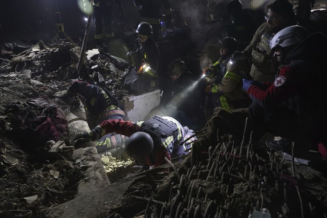 Rescue workers clear the rubble of a residential house destroyed by a Russian drone strike in Zaporizhzhia, Ukraine, Friday, March 21, 2025. (Phootr by Kateryna Klochko/AP Photo)