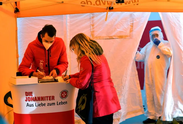 A medical worker waits for people to test them with a free antigen quick test in a tent on the ground of the Dresden fair, amid the coronavirus disease (COVID-19) pandemic in Dresden, Germany, March 9, 2021. (Photo by Matthias Rietschel/Reuters)