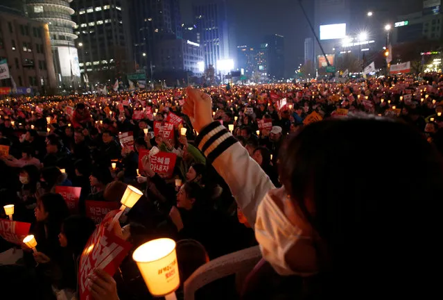 Protesters carrying lit candles shout slogans at a protest calling South Korean President Park Geun-hye to step down, in Seoul, South Korea, November 19, 2016. (Photo by Kim Hong-Ji/Reuters)