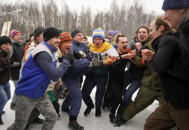 Participants run into each other during a traditional fighting game to celebrate Maslenitsa, also known as Pancake Week, which is a pagan holiday marking the end of winter, in Moscow region, Russia on March 14, 2021. (Photo by Tatyana Makeyeva/Reuters)