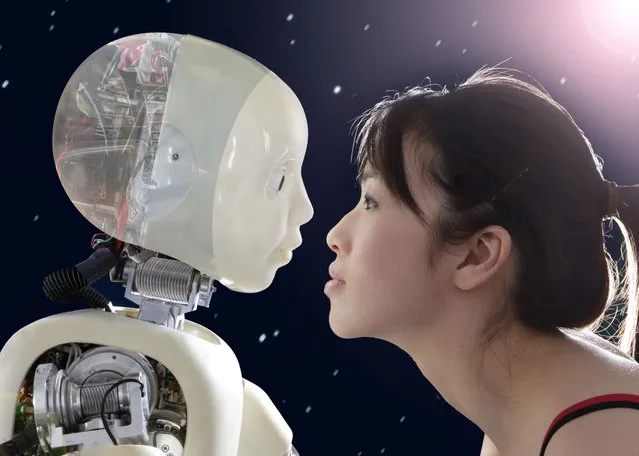 Woman and digital composite robot face to face. (Photo by Peter Cade/Getty Images)
