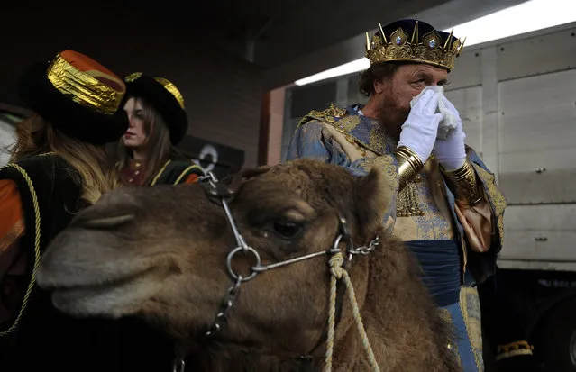 A man dressed as one of the Three Wise Men blows his nose before the start of the Epiphany parade in Gijon, Spain, January 5, 2016. (Photo by Eloy Alonso/Reuters)