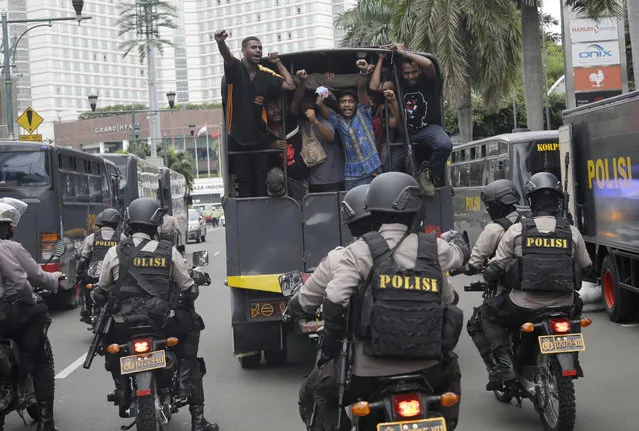 West Papuan protesters shout slogans as they are taken away on a police truck under armed police escort during a rally calling for the remote region's independence, in Jakarta, Indonesia, Thursday, December 1, 2016. (Photo by Dita Alangkara/AP Photo)