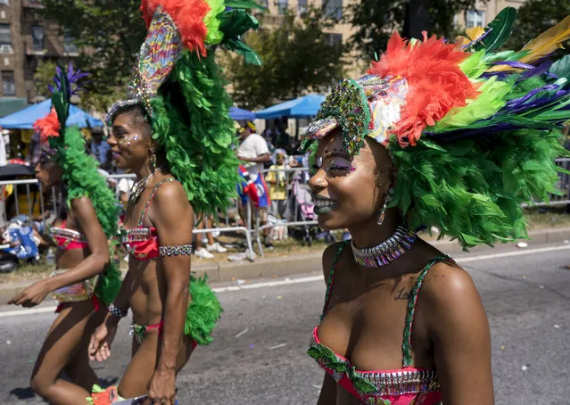 Participants take part in the West Indian American Day Parade in the Brooklyn borough of New York, Monday, September 3, 2018. New York's Caribbean community has held annual Carnival celebrations since the 1920s, first in Harlem and then in Brooklyn, where festivities happen on Labor Day. (Photo by Craig Ruttle/AP Photo)