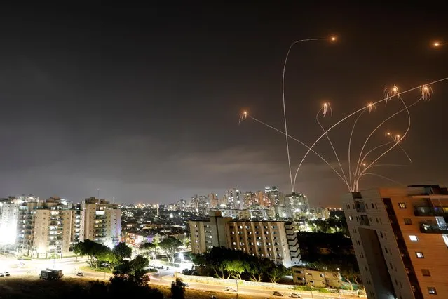 Streaks of light are seen as Israel's Iron Dome anti-missile system intercepts rockets launched from the Gaza Strip towards Israel, as seen from Ashkelon, Israel on May 10, 2021. Picture taken with slow shutter speed. (Photo by Amir Cohen/Reuters)