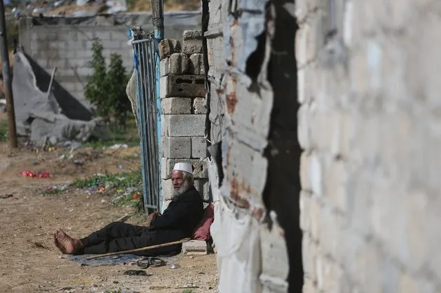 A Palestinian man sits outside his dwelling in Khan Younis in the southern Gaza Strip, December 1, 2015. (Photo by Ibraheem Abu Mustafa/Reuters)