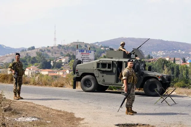 Lebanese army members patrol on the Lebanese side of the Lebanese-Israeli border in the southern village of Kfar Kila, with the Israeli town of Metula in the background, Lebanon, Monday, October 9, 2023. Lebanese and Israeli army soldiers have gathered in larger numbers along the border Monday, the U.N.-drawn Blue Line, after Israeli troops and militant group Hezbollah exchanged shelling on Sunday. (Photo by Hassan Ammar/AP Photo)