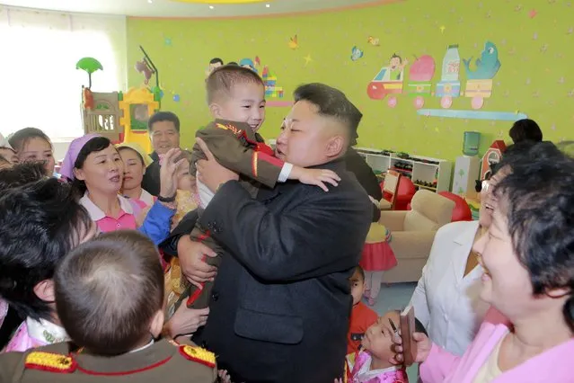 North Korean leader Kim Jong Un (L) visits the Pyongyang Baby Home and Orphanage on New Year's Day in this photo released by North Korea's Korean Central News Agency (KCNA) in Pyongyang January 2, 2015. (Photo by Reuters/KCNA)