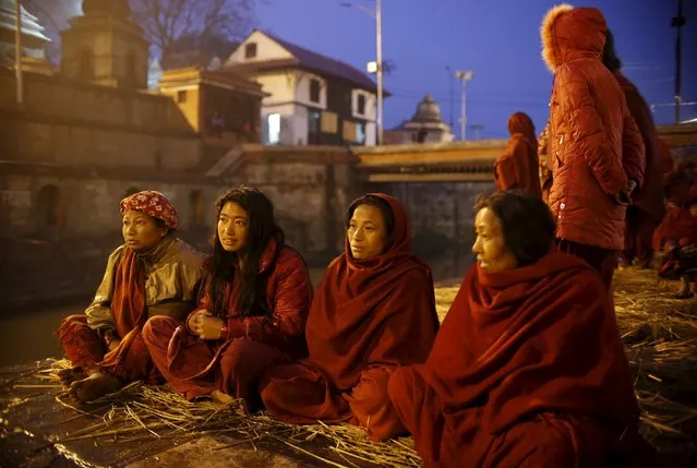 Devotees gather near the bank of the Bagmati River at Pashupatinath Temple to offer prayers during the Swasthani Brata Katha festival in Kathmandu, Nepal, February 8, 2016. (Photo by Navesh Chitrakar/Reuters)