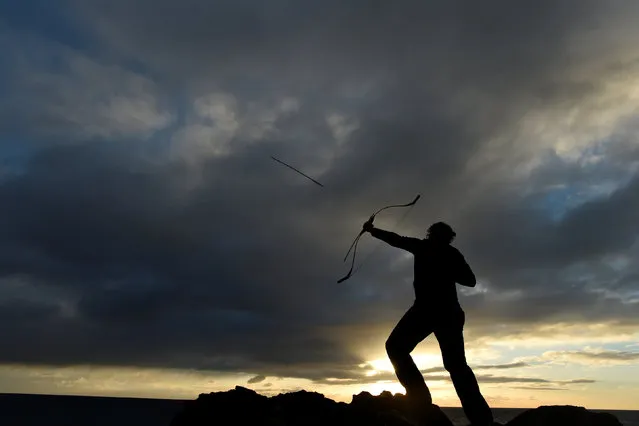 An archer fires an arrow into the sea as part of a Claiming of the Waters tradition at the 800-year-old Hook Head lighthouse in Hook Head, Ireland January 1, 2017. (Photo by Clodagh Kilcoyne/Reuters)