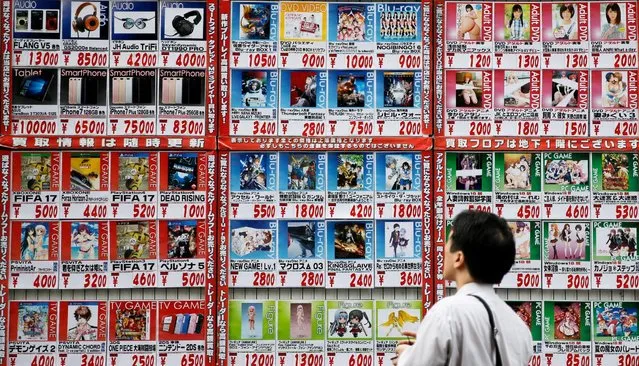 A man looks at price lists outside a store in Tokyo, Japan, October 4, 2016. (Photo by Toru Hanai/Reuters)