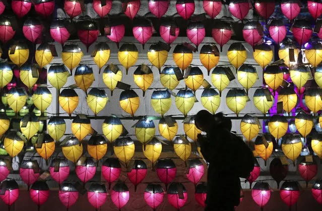A woman prays in front of a wall of lanterns to celebrate the New Year at the Jogyesa Buddhist temple in Seoul, South Korea, Monday, December 31, 2018. (Photo by Ahn Young-joon/AP Photo)