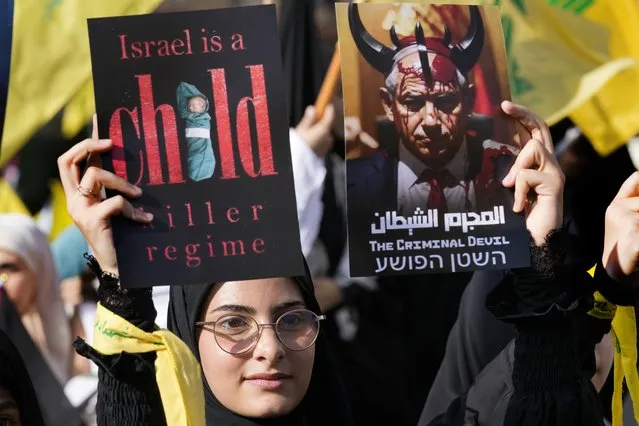 A supporter of the Iranian-backed Hezbollah group hold posters against the Israeli Prime Minister Benjamin Netanyahu, as she waits the speech of Hezbollah leader Sayyed Hassan Nasrallah during a rally to commemorate Hezbollah fighters who were killed in South Lebanon last few weeks while fighting against the Israeli forces, in Beirut, Lebanon, Friday, November 3, 2023. Nasrallah's speech had been widely anticipated throughout the region as a sign of whether the Israel-Hamas conflict would spiral into a regional war. (Phoot by Hussein Malla/AP Photo)