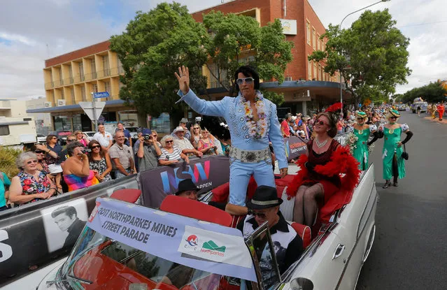 Elvis Presley tribute artist Damian Mullin from Melbourne rides in a convertible during a street parade at the 25th annual Parkes Elvis Festival in the rural Australian town of Parkes, west of Sydney, January 14, 2017. (Photo by Jason Reed/Reuters)