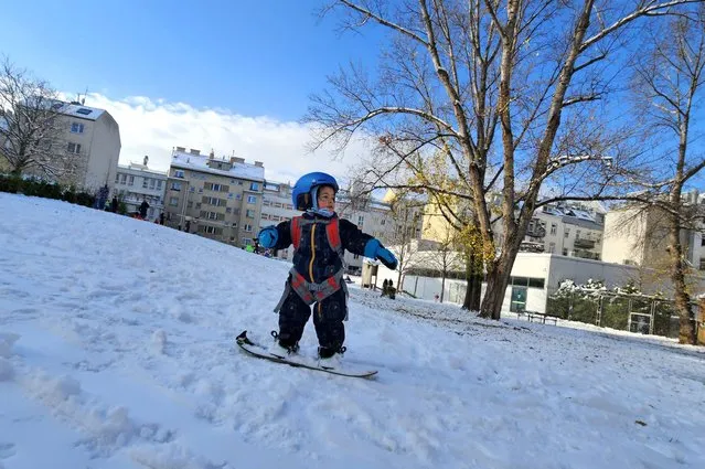 A two years old boy snowboards in Steinhage park in Vienna, Austria on December 3, 2023, as Vienna's landscape has changed to a winter look after two days of snowfall. (Photo by Joe Klamar/AFP Photo)