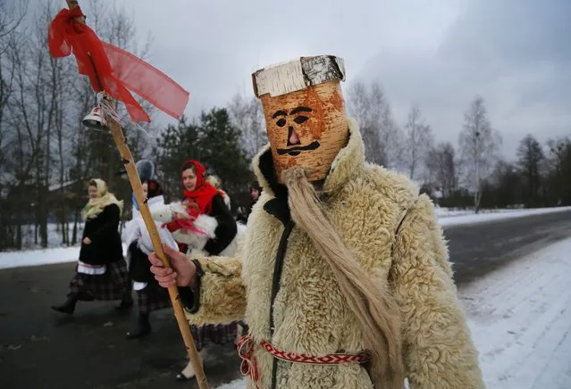 Belarusians prepare to mark “Kolyadki” in the village of Osovo, 180 km (112 miles) south of Minsk, Belarus, Monday, January 13, 2014. Kolyadki is a pagan winter holiday, which has over the centuries merged with Orthodox Christmas celebrations. Orthodox Belarusians mark the New Year according to the Julian calendar on January 13. (Photo by Sergei Grits/AP Photo)