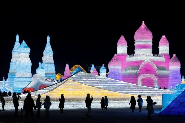 People visit ice sculptures at the Harbin Ice and Snow World, during Harbin International Ice and Snow Festival, in Heilongjiang province, China on January 5, 2024. (Photo by Tingshu Wang/Reuters)