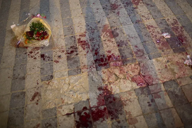 Blood stains the street at the scene of a stabbing attack in Jaffa, a mixed Jewish-Arab part of Tel Aviv, Israel, Tuesday, March 8, 2016. (Photo by Oded Balilty/AP Photo)