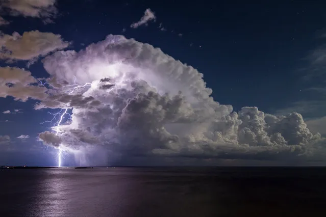 “Lightning from an Isolated Storm over Cannes Bay”. A thunderstorm during a full moon off the south of France. (Photo by Serge Zaka/Royal Meteorological Society’s Weather Photographer of the Year Awards)
