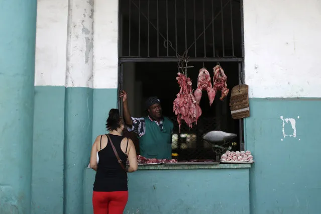 A woman shops at a butcher's stall in Havana, Cuba March 18, 2016. (Photo by Ueslei Marcelino/Reuters)