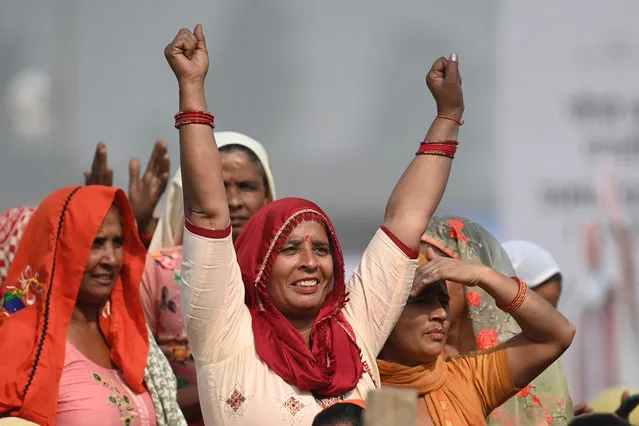 A woman reacts during an event to lay the foundation stone of the Noida International Airport in Jewar on November 25, 2021. (Photo by Money Sharma/AFP Photo)