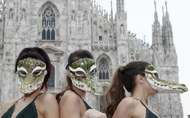 PETA (People for the Ethical Treatment of Animals) activists wear crocodile masks during a demonstration against the use of crocodile skins ahead of Milan's Fashion Week, in Milan's Duomo Square, Italy, Tuesday, February 21, 2017. Milan Fashion Week opens Wednesday. (Photo by Antonio Calanni/AP Photo)