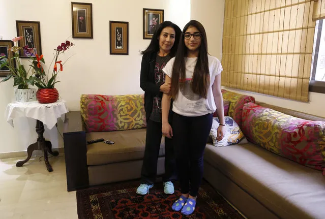 Rima Bader, 44, poses with her daughter Reina, 13, inside their apartment in Beirut February 25, 2014. Rima is an interior designer but she says that when she was growing up she wanted to be an engineer. Rima wants her daughter to work in whatever profession she chooses, but she says she would love to see her in the field of engineering. Reina says she will finish education when she is around 21 years old. She wants to be an architect when she grows up. (Photo by Jamal Saidi/Reuters)