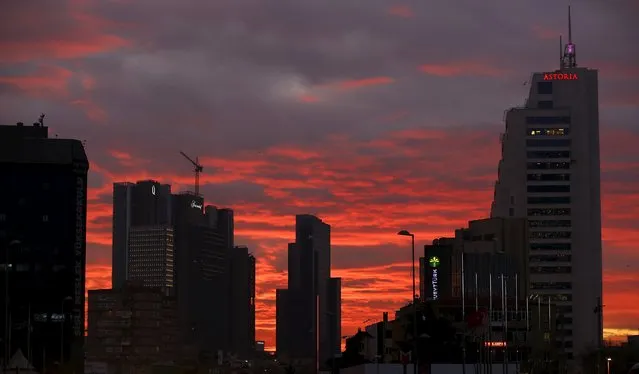 The sun sets behind Sisli business district, which comprises leading Turkish companies' headquarters and popular shopping malls, in Istanbul, Turkey February 1, 2016. (Photo by Murad Sezer/Reuters)