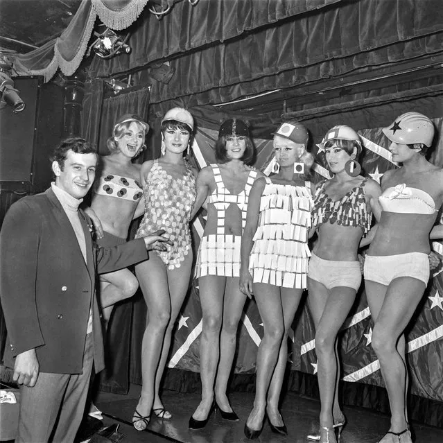 French swimmer Alain Gottvalles presents the Paco Rabanne's swimsuits collection “Mec'Art” on April 22, 1966 in the “Crazy Horse Saloon” cabaret at Paris. The clothing are weared by the woman dancers. (Photo by AFP Photo via Getty Images)