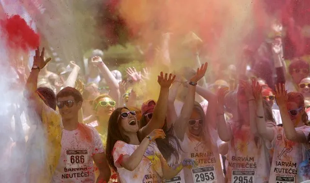 Participants throw colored powder as they take part in the Get Rainbowed run in Prague May 23, 2015. (Photo by David W. Cerny/Reuters)