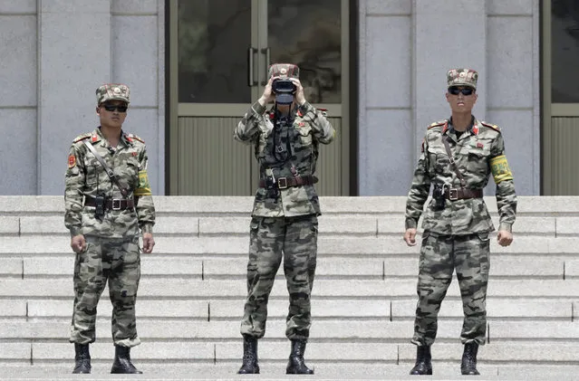 In this June 12, 2019, photo, North Korean soldiers look at the South side, seen during a press tour at the Panmunjom in the Demilitarized Zone (DMZ), South Korea. U.S. President Donald Trump on Saturday, June 29, 2019, invited North Korean leader Kim Jong Un to shake hands during a visit by Trump to the DMZ with South Korea. (Photo by Lee Jin-man/AP Photo)