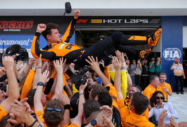 McLaren's Lando Norris is thrown in the air by his team as he celebrates winning the Miami Grand Prix on May 5, 2024. (Photo by Brian Snyder/Reuters)