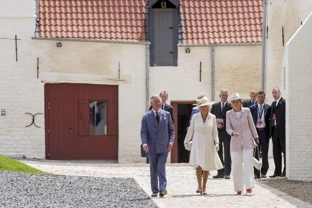 Britain's Prince Charles and Camilla, the Duchess of Cornwall, walk with Belgium's Princess Astrid (R) during a ceremony for the opening of the Hougoumont farm as part of the bicentennial celebrations for the Battle of Waterloo, near Waterloo, Belgium June 17, 2015. The commemorations for the 200th anniversary of the Battle of Waterloo will take place in Belgium on June 19 and 20. REUTERS/Geert Vanden Wijngaert/Pool
